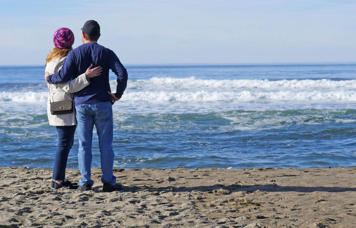 Couple on beach watching waves