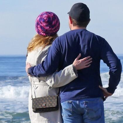 Couple on beach watching waves