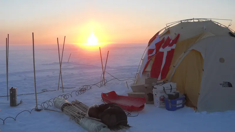 An ice core drilling camp in Greenland at sunset. 