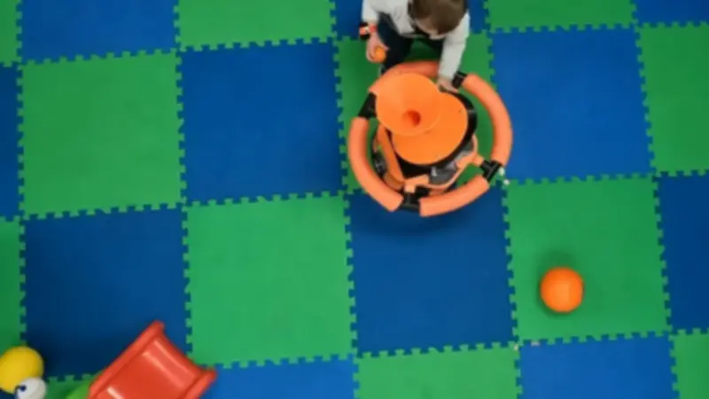 Go-Bot and child in play room, photo courtesy OSU College of Engineering.
