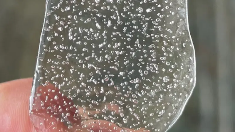 A close up image of old ice with bubbles inside