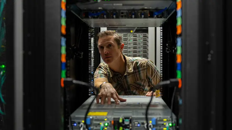 Scientist surrounded by computers