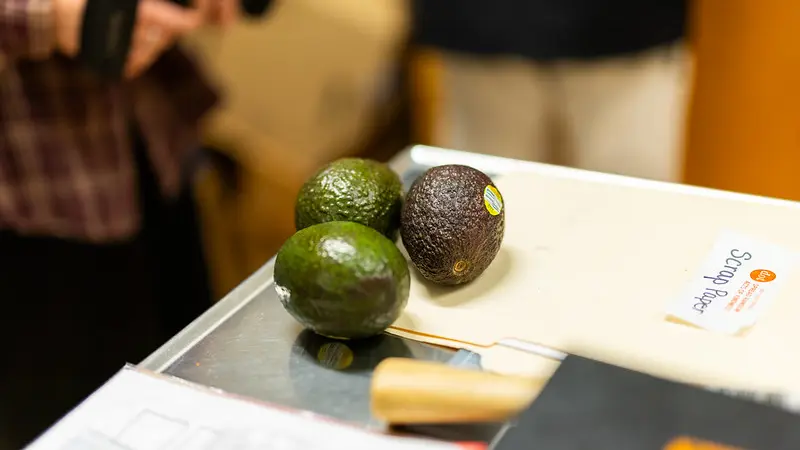 Three avocados on a table