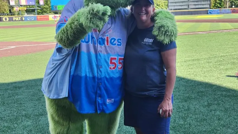 Image of Eugene Emeralds mascot and Leigh Torres of the Marine Mammal Institute.