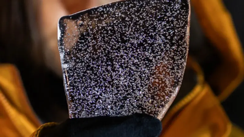 Up close image of slice of Antarctic ice core that shows air bubbles containing ancient gasses