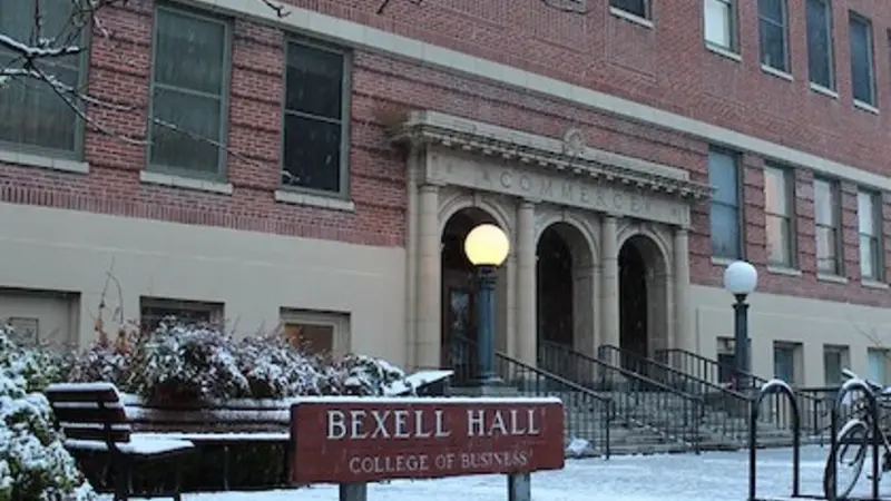Image of Bexell Hall in the winter; light covering of snow on the ground