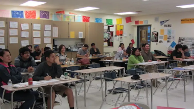 Image of high school students sitting in a classroom with colorful papers on the walls