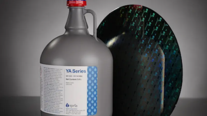 Image of a large gray jug with a sample of the dark, reflective material next to it