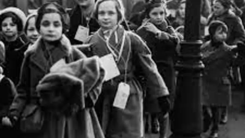 Black and white image of the "Kindertransport," with children gathered around a train