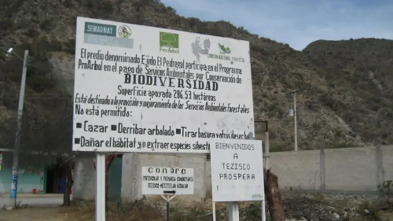 A sign tells visitors in Spanish that this community participates in Mexico’s Payments for Ecosystems Service Program for biodiversity conservation
