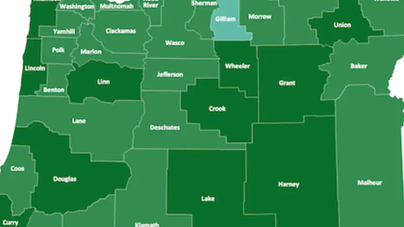 Image is a green map of Oregon, with counties different shades of green based on their level of child care desert status for children ages 0-2. Only one county, Gilliam, is not a desert.