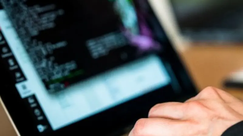 Hands at computer keyboard