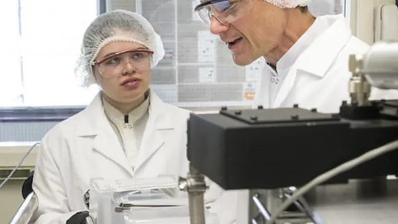 PhD student Jessica Peterson and Professor John Conley discussing the operation of one of his group’s atomic layer deposition (ALD) systems.