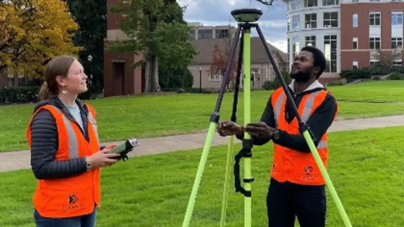 Ellery Ohlwiler and David Abiola collect Global Navigation Satellite System (GNSS) data on the OSU campus. Photo by Chris Parrish, OSU College of Enginering.