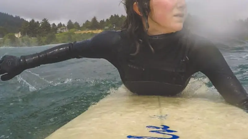 Maia Insinga paddles her surfboard off the Oregon coast. Photo by Maia Insinga.