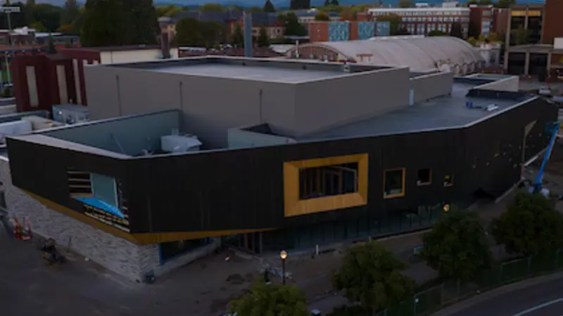 An aerial photo shows the large PRAx building under construction on OSU's campus.