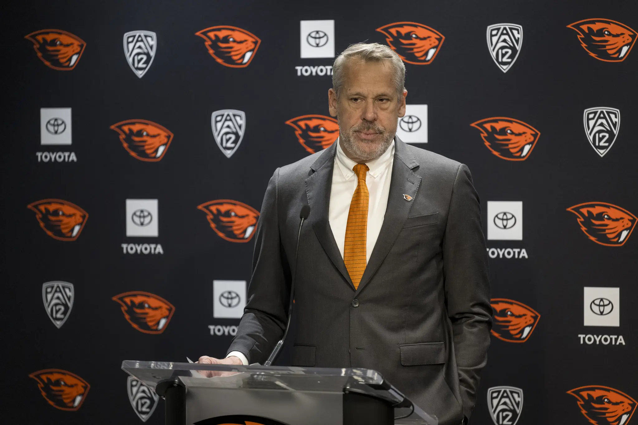 Scott Barnes standing in front of a podium.