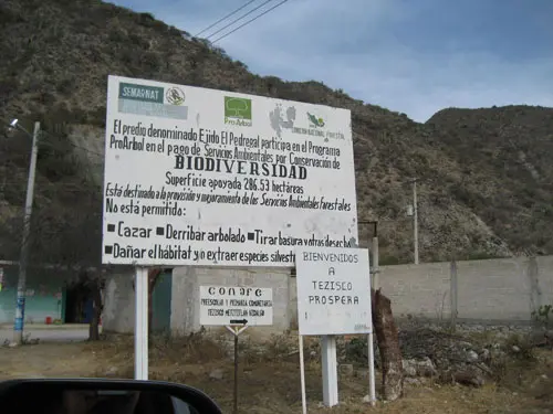 A sign tells visitors in Spanish that this community participates in Mexico’s Payments for Ecosystems Service Program for biodiversity conservation