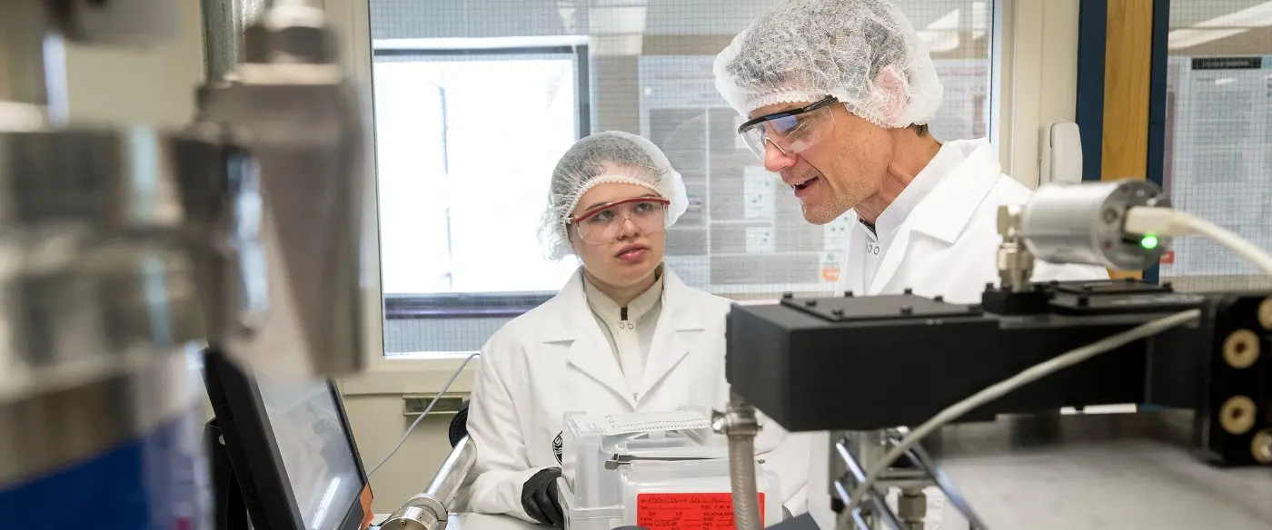 PhD student Jessica Peterson and Professor John Conley discussing the operation of one of his group’s atomic layer deposition (ALD) systems.