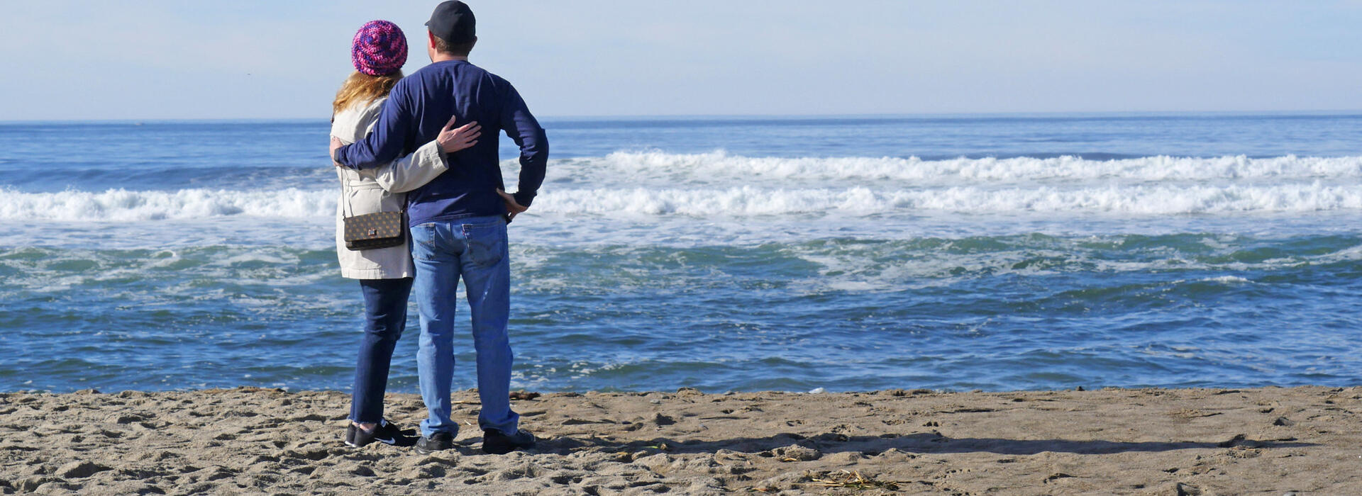 Couple on beach watching waves