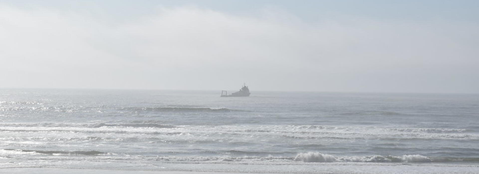 A vessel is seen in the ocean from land at Driftwood Beach. 