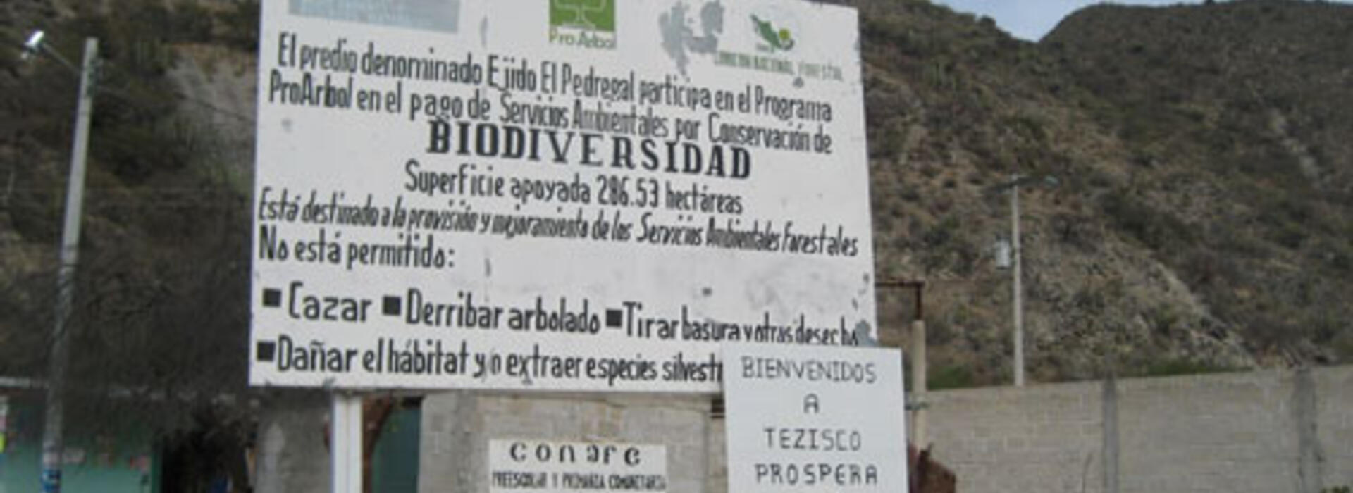 A sign tells visitors in Spanish that this community participates in Mexico’s Payments for Ecosystems Service Program for biodiversity conservation
