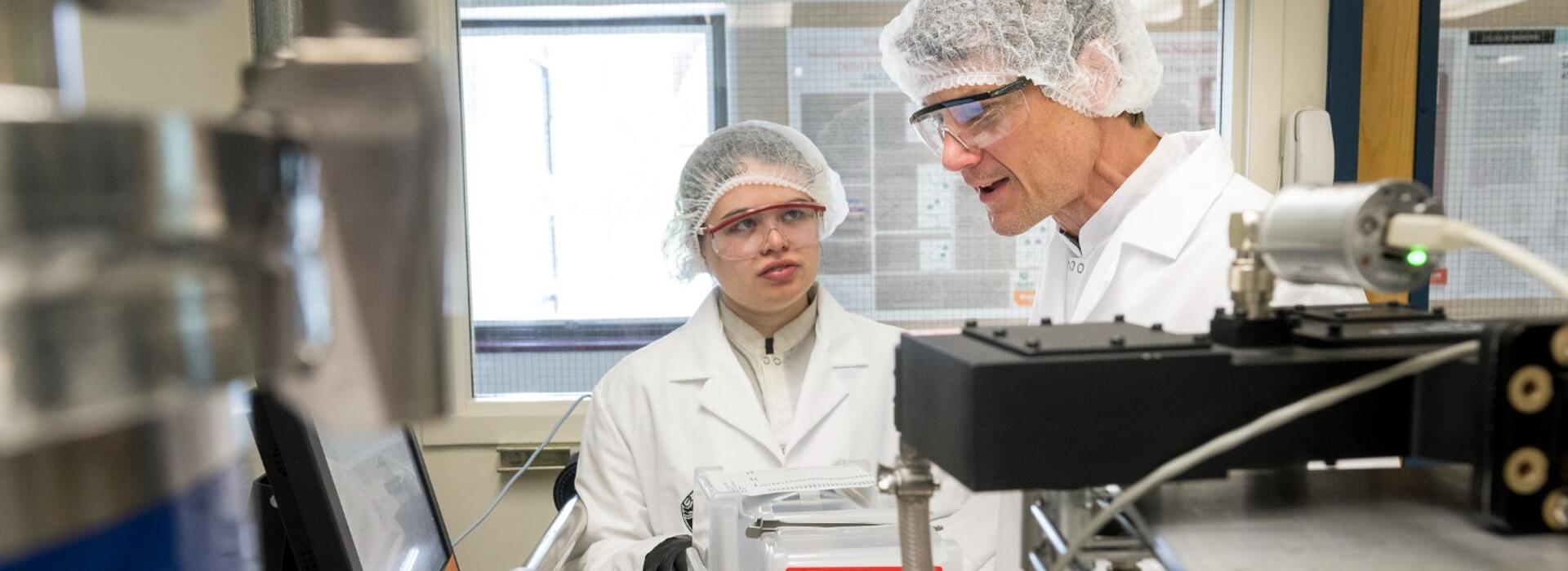 PhD student Jessica Peterson and Professor John Conley discussing the operation of one of his group’s atomic layer deposition (ALD) systems.