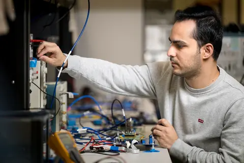 Ramin Javadi in lab, photo by Karl Maasdam